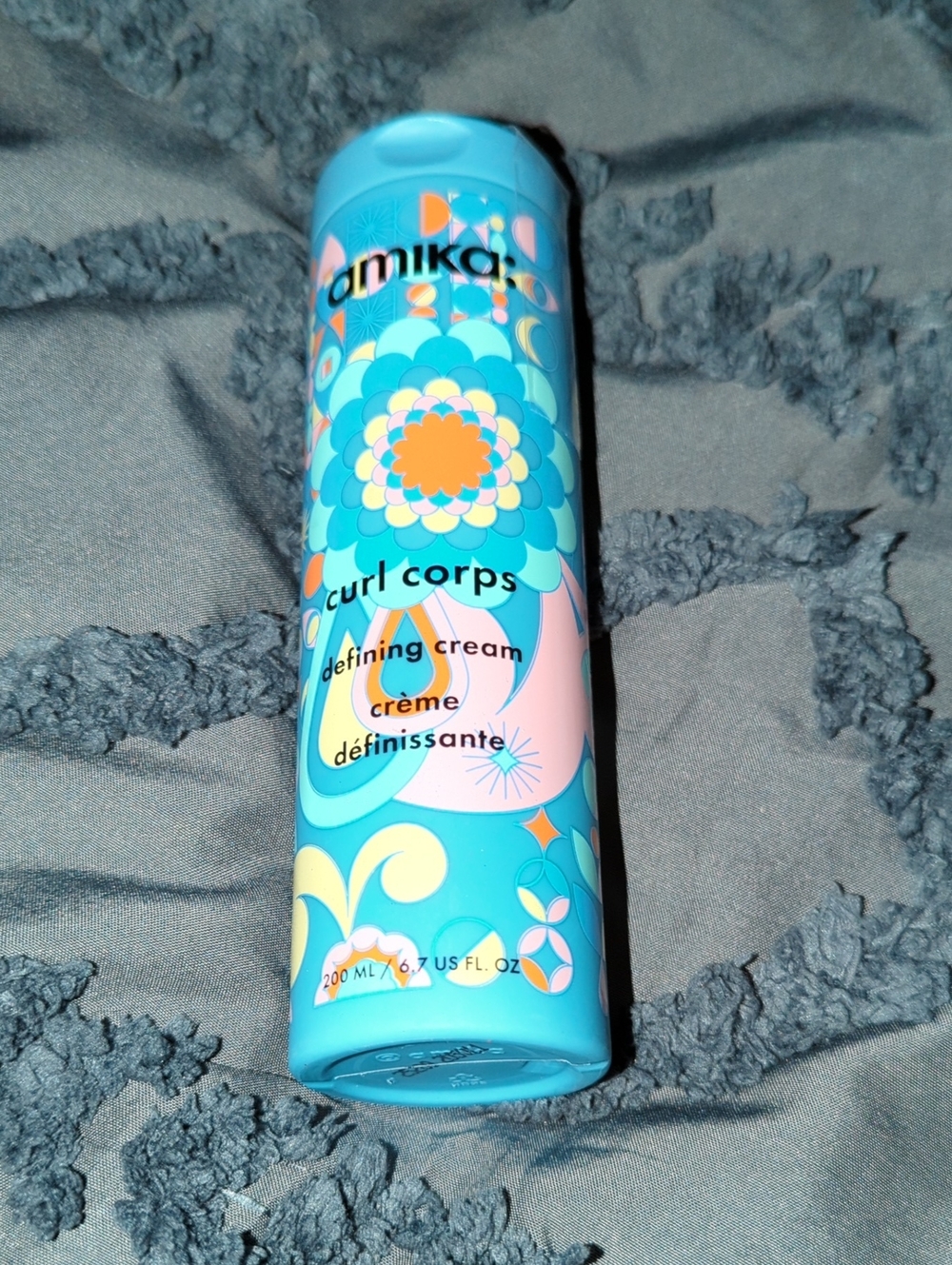 amika Curl Corps Defining Cream — turquoise with orange & pink accents